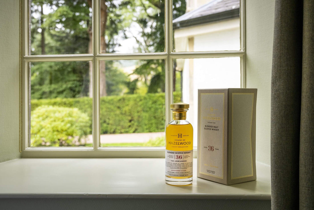 The Lowlander bottle sitting next to its box in front of a window.